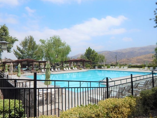 view of pool with a mountain view and a patio