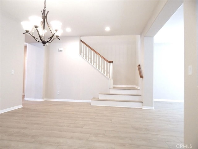 stairs with a chandelier and wood-type flooring