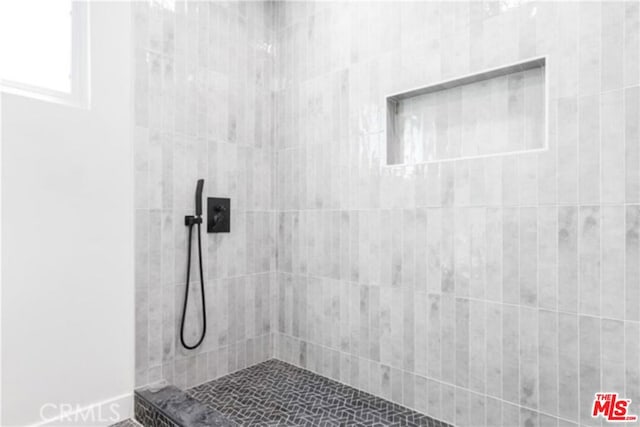 bathroom with a tile shower