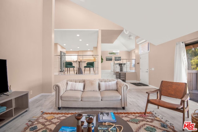 living room featuring light hardwood / wood-style floors and lofted ceiling