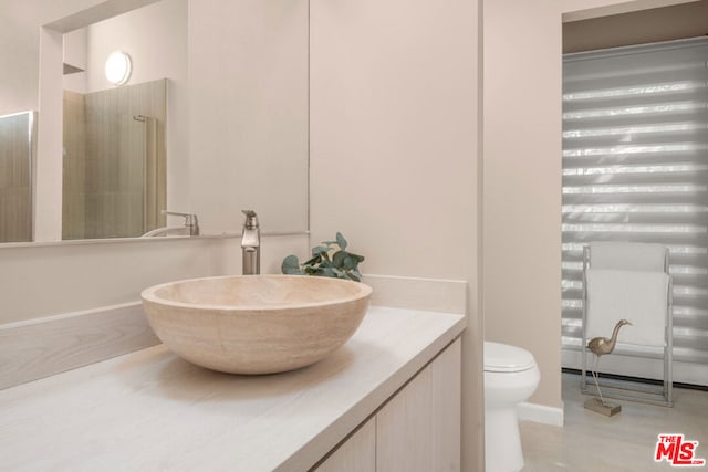 bathroom with walk in shower, vanity, hardwood / wood-style floors, and toilet