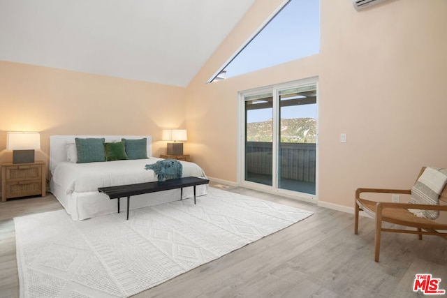 bedroom with access to outside, light hardwood / wood-style flooring, and high vaulted ceiling