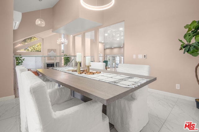 dining area featuring a notable chandelier, a towering ceiling, and a wall mounted AC