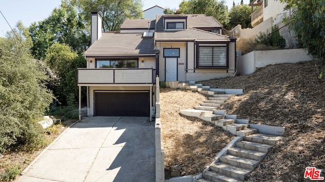 view of front of property with a balcony and a garage