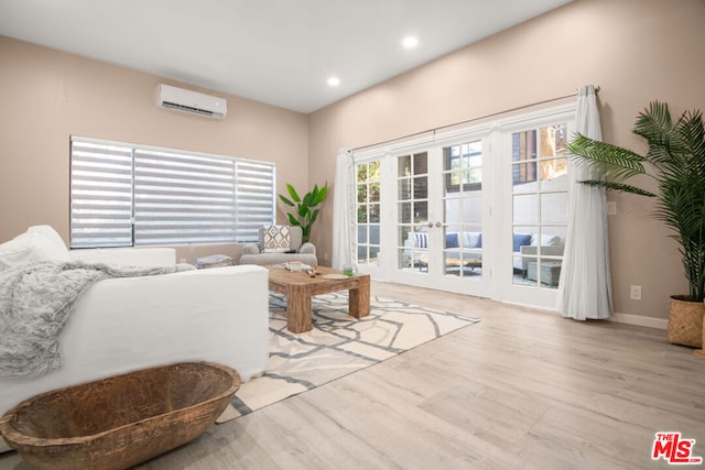 living room with light wood-type flooring and a wall mounted AC