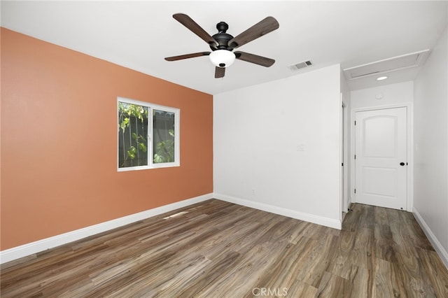 spare room featuring ceiling fan and dark hardwood / wood-style floors