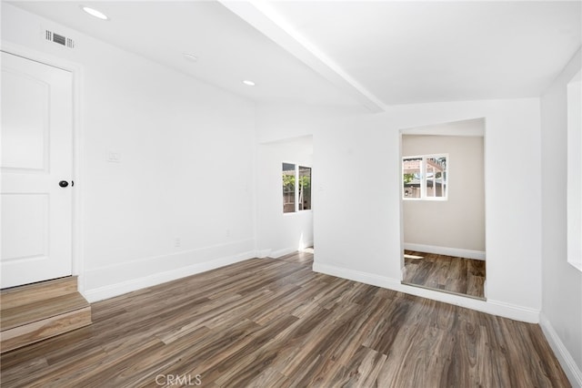 unfurnished room featuring lofted ceiling with beams and dark hardwood / wood-style floors