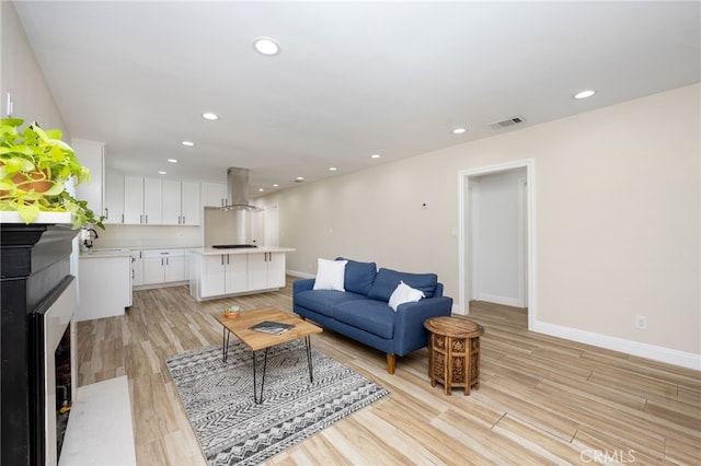 living room featuring sink and light wood-type flooring