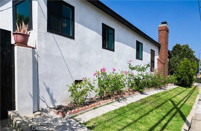 view of side of home featuring a yard