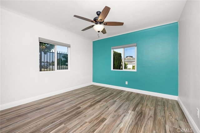 spare room with ceiling fan and hardwood / wood-style flooring