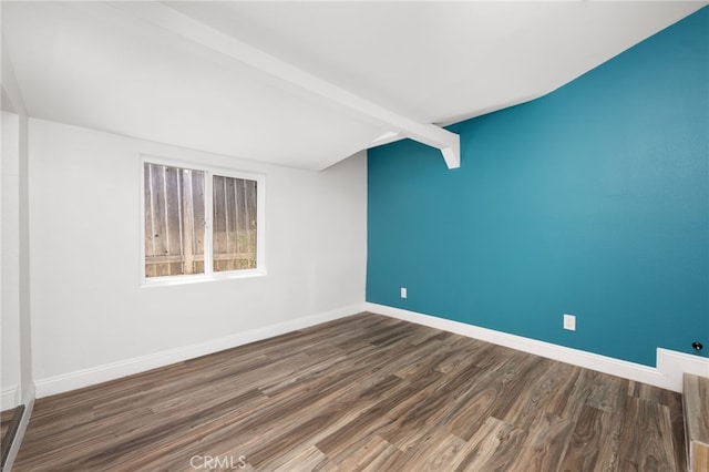 unfurnished room featuring beam ceiling and dark wood-type flooring