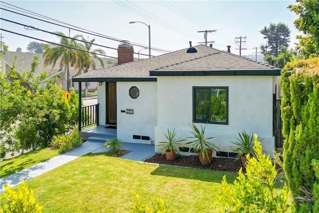 rear view of property with a lawn