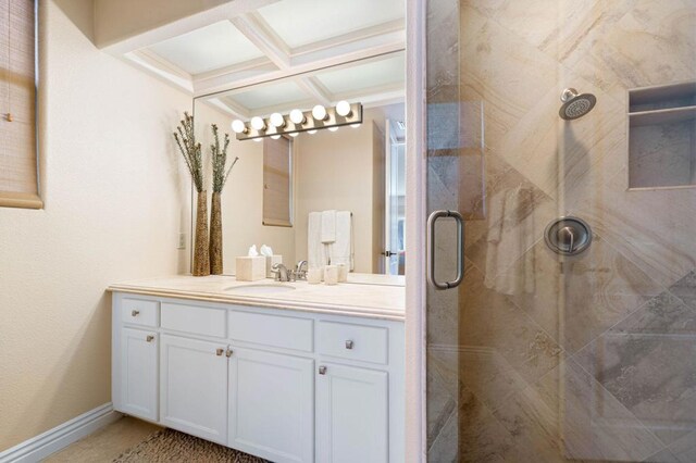 bathroom featuring coffered ceiling, a shower with door, and vanity