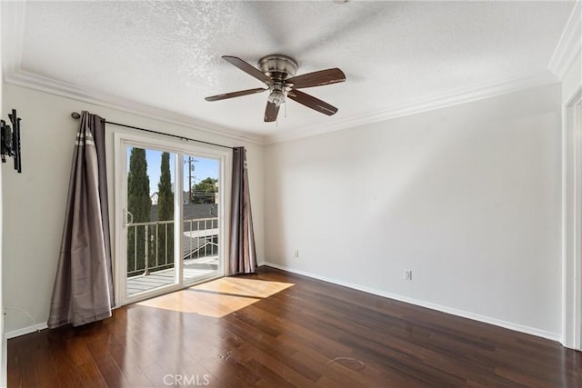 empty room featuring a textured ceiling, dark hardwood / wood-style floors, ceiling fan, and ornamental molding