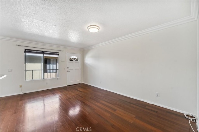 unfurnished room featuring a textured ceiling, ornamental molding, and dark wood-type flooring