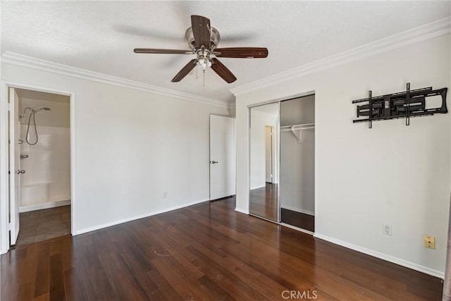 unfurnished bedroom with a closet, dark hardwood / wood-style floors, ceiling fan, and ornamental molding