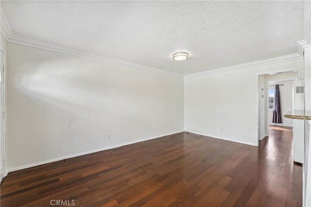 unfurnished room with a textured ceiling, dark hardwood / wood-style floors, and crown molding