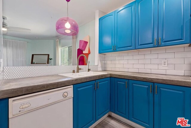 kitchen with backsplash, blue cabinets, dishwasher, and sink