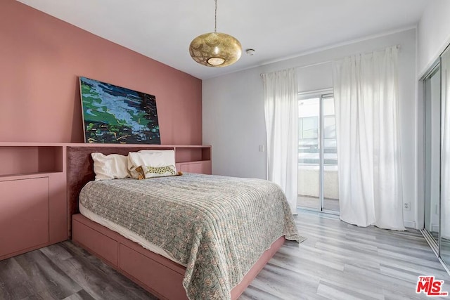 bedroom featuring hardwood / wood-style flooring and access to outside