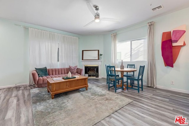 living room featuring ceiling fan and hardwood / wood-style flooring