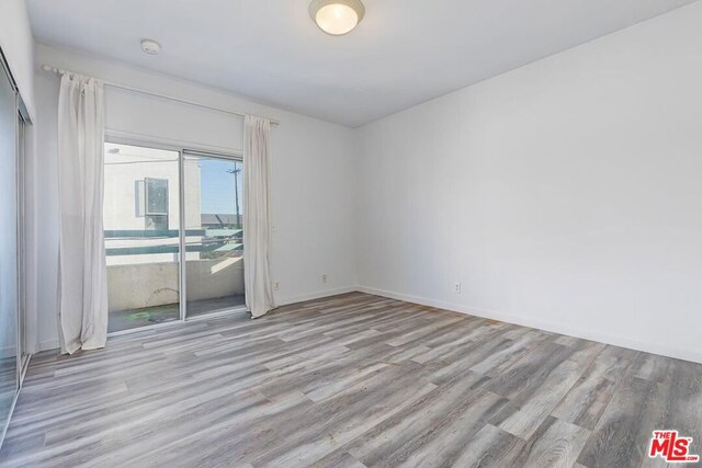 unfurnished room with light wood-type flooring