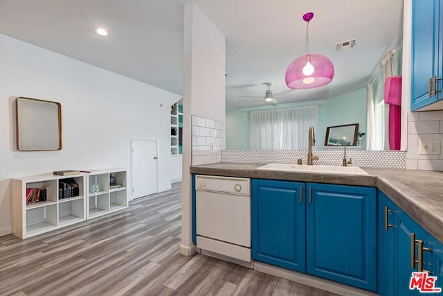 kitchen with hardwood / wood-style floors, blue cabinets, dishwasher, and sink