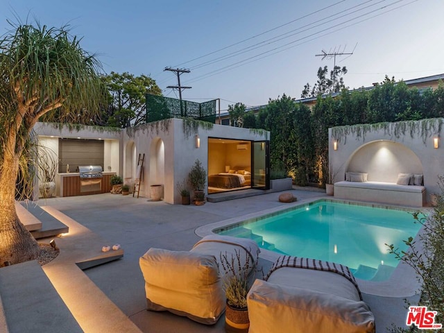 view of pool featuring a patio, grilling area, and a fireplace