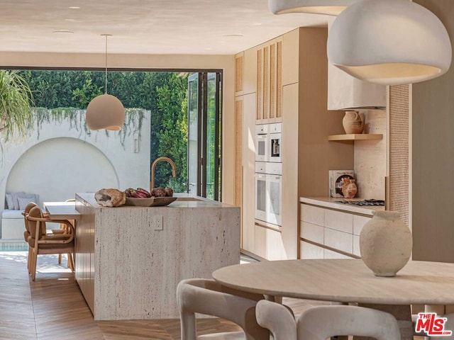 dining area featuring light hardwood / wood-style floors and sink