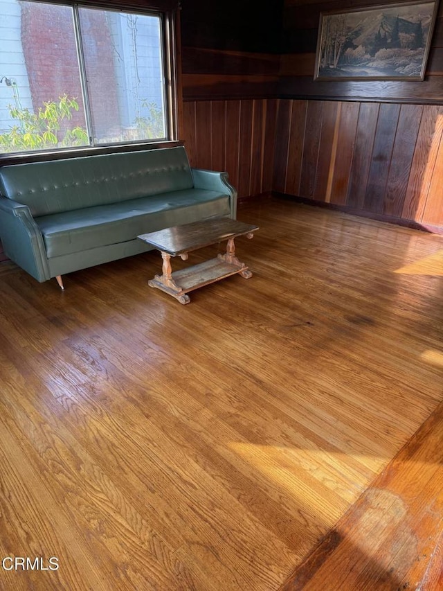 interior space with hardwood / wood-style floors and wood walls