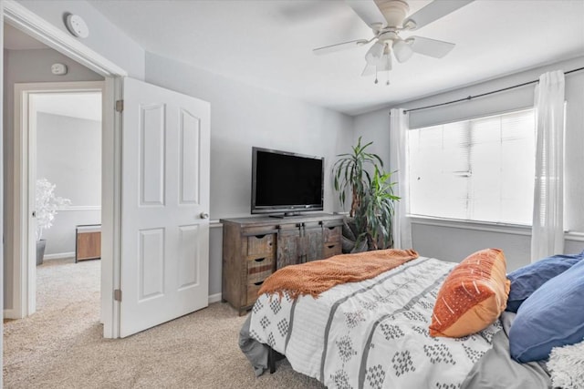 bedroom featuring light colored carpet and ceiling fan