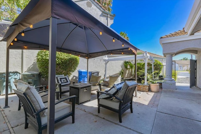 view of patio / terrace featuring a gazebo, area for grilling, and an outdoor living space with a fire pit