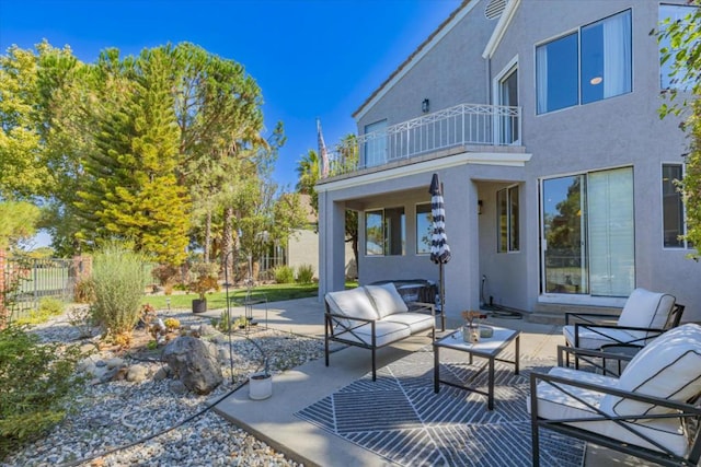 view of patio featuring outdoor lounge area and a balcony