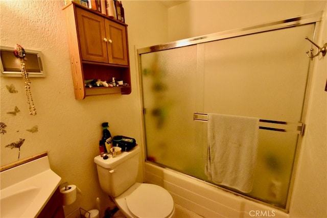 full bathroom with vanity, toilet, and combined bath / shower with glass door