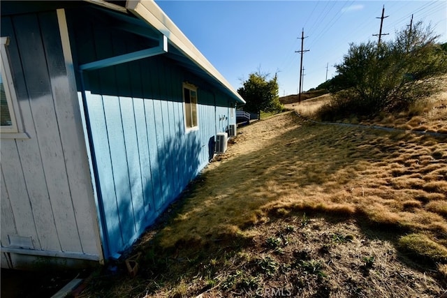 view of side of home featuring central AC unit