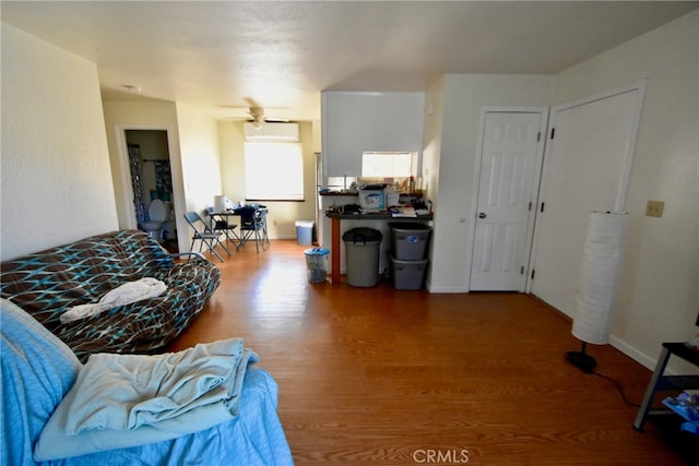 living room with wood-type flooring and ceiling fan