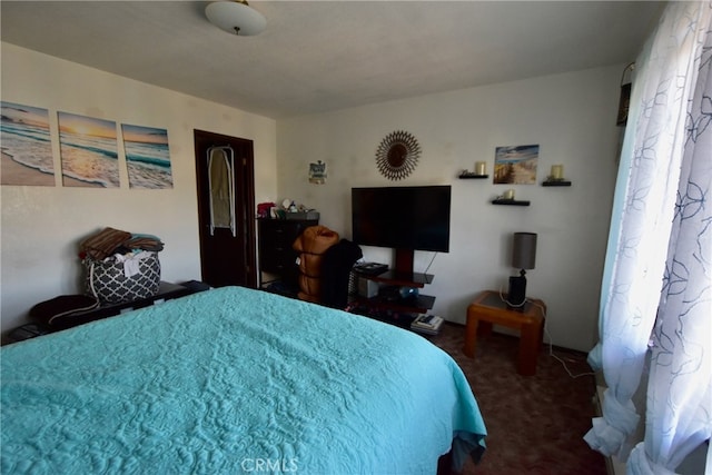 bedroom featuring dark colored carpet