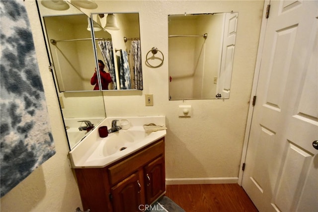 bathroom with hardwood / wood-style floors and vanity