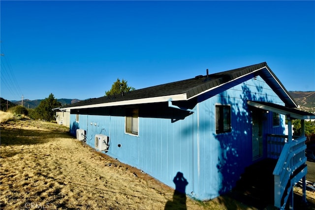 view of property exterior with a mountain view