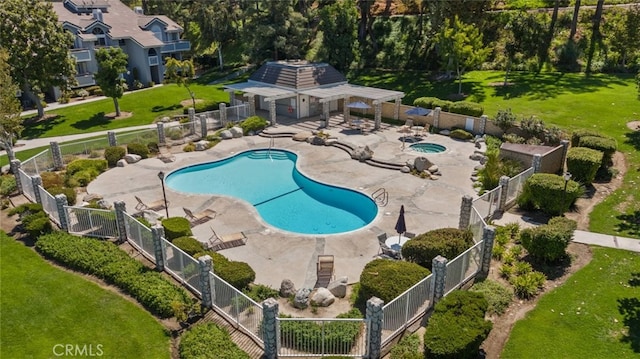 view of pool featuring a hot tub, a patio area, and a lawn