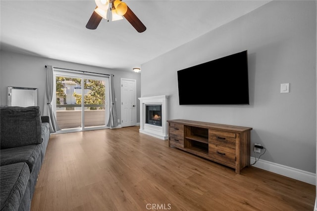 living room featuring hardwood / wood-style flooring and ceiling fan