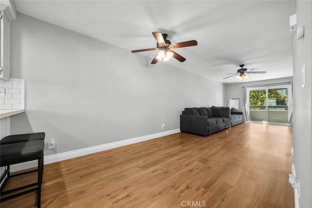 living room featuring light wood-type flooring and ceiling fan