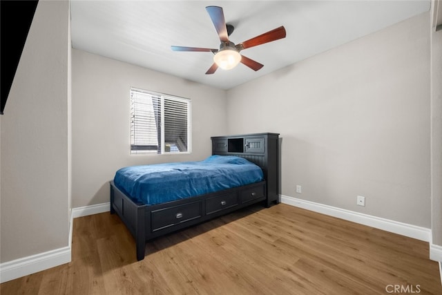 bedroom with ceiling fan and wood-type flooring