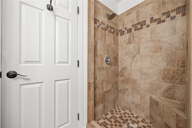 bathroom with tiled shower