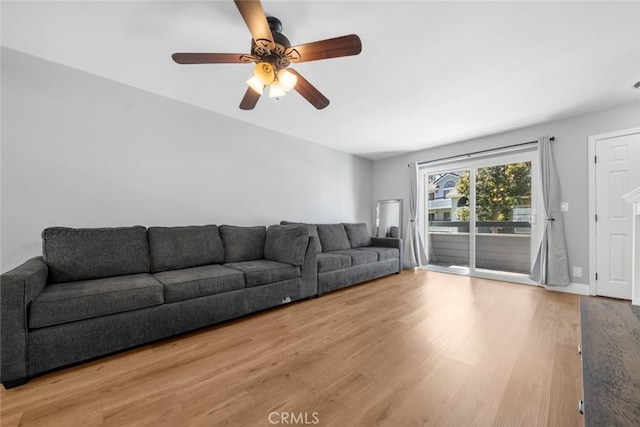 living room featuring wood-type flooring and ceiling fan