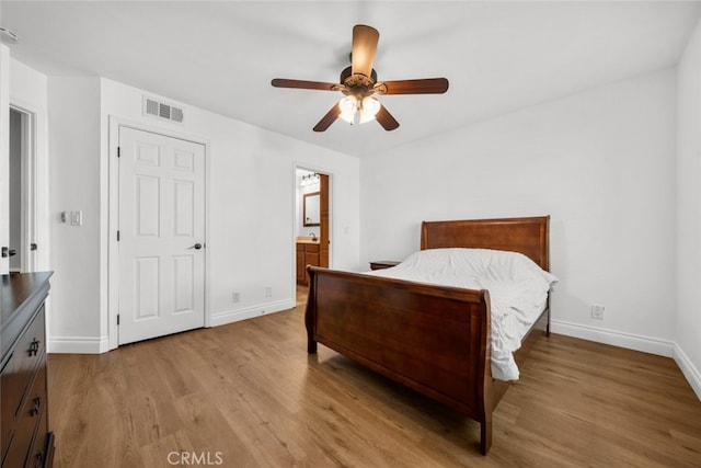 bedroom featuring ceiling fan, ensuite bathroom, and light hardwood / wood-style flooring