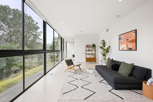 tiled living room with floor to ceiling windows