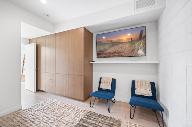 sitting room with light hardwood / wood-style flooring