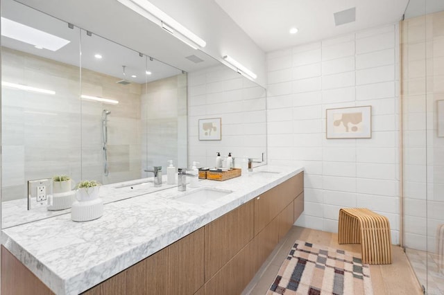 bathroom featuring vanity, a shower, tile walls, and wood-type flooring