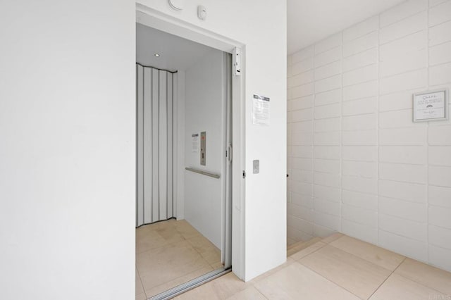 bathroom featuring tile patterned flooring and elevator