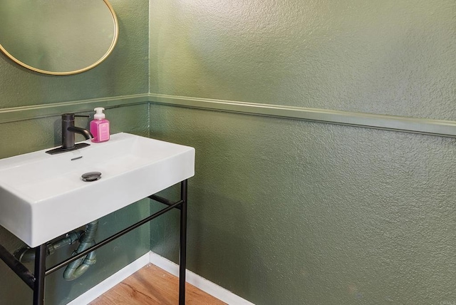 bathroom with wood-type flooring and sink